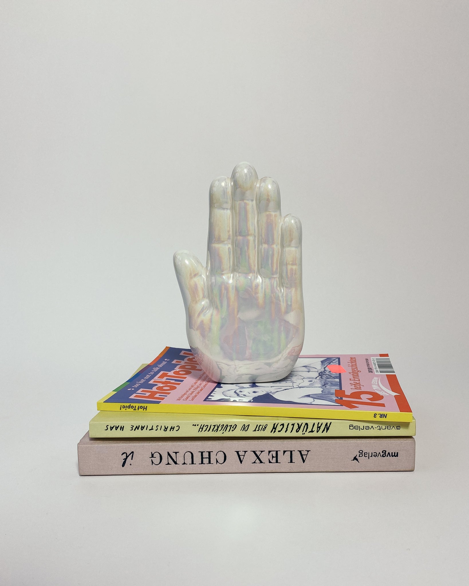 Perlmutt Buchstütze in Form einer Hand